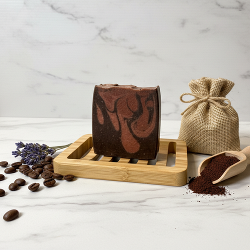 Barista's Blend tallow soap styled with coffee beans, dried lavender, and espresso grounds on white marble surface